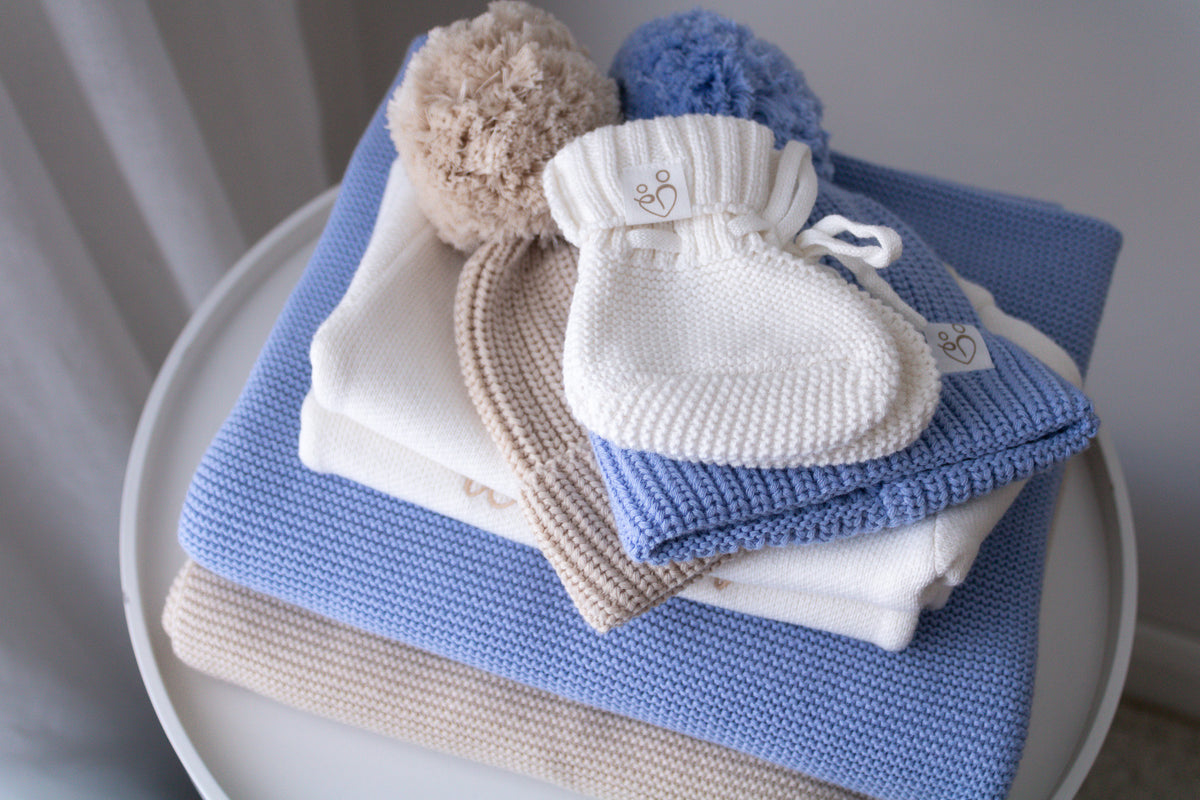 Blue baby gift set with knitted blanket, ivory booties and matching knit accessories