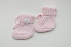 Light pink knitted baby booties with textured knit, ribbed cuffs, soft tie closures and Snuggle Threads woven label, displayed as a matching pair.