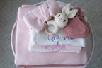 Personalised baby gift set with pink knitted blanket, embroidered romper, knitted booties and crochet bunny rattle