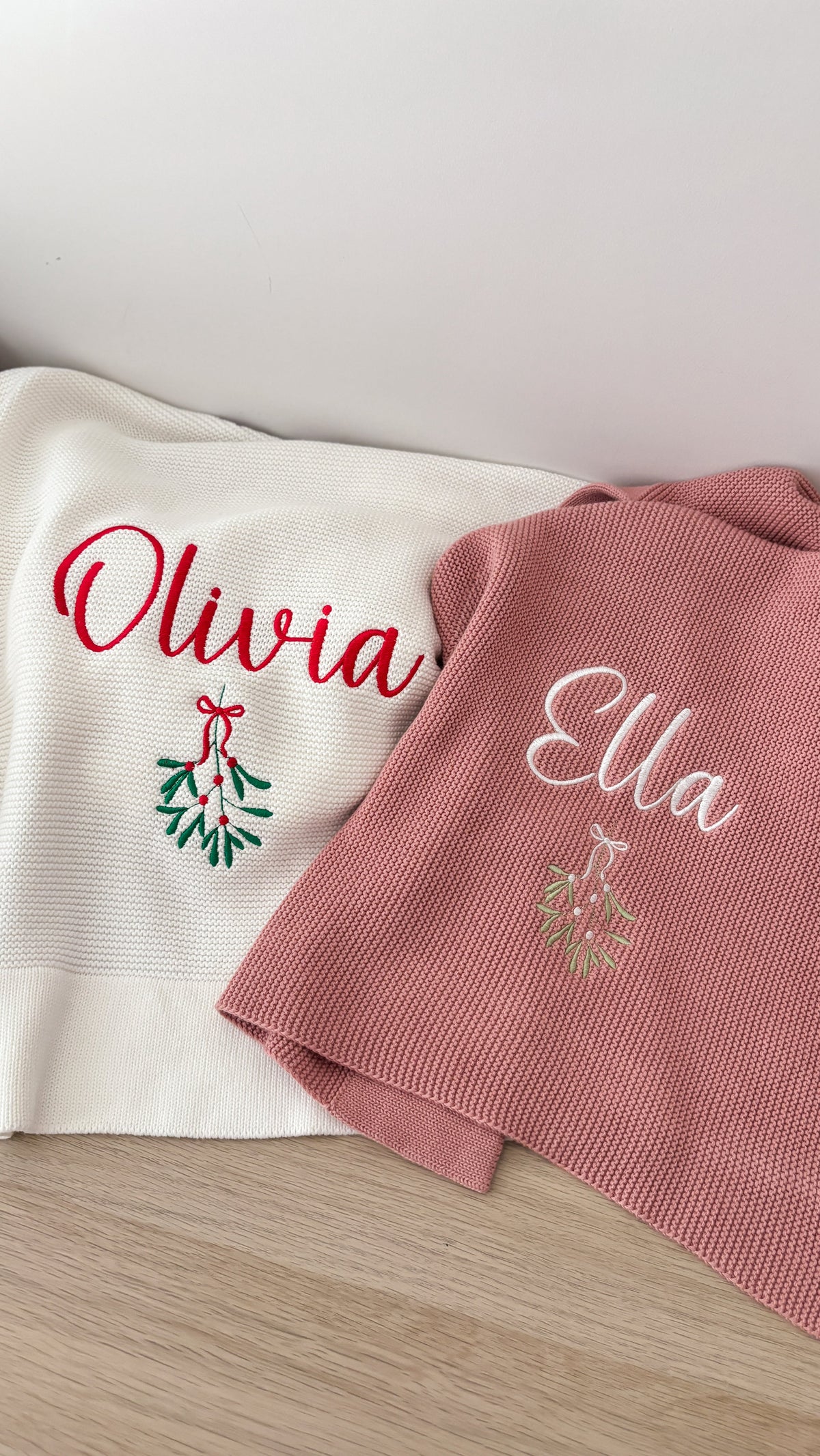 Personalised knitted Christmas baby blankets with embroidered names and mistletoe design