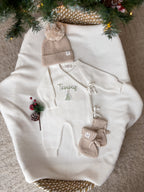 Personalised ivory knitted Christmas baby wrap romper with custom name and green Christmas tree embroidery, beige hat and booties