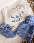Personalised ivory baby romper with blue Hello World embroidery, matching knitted hat and booties
