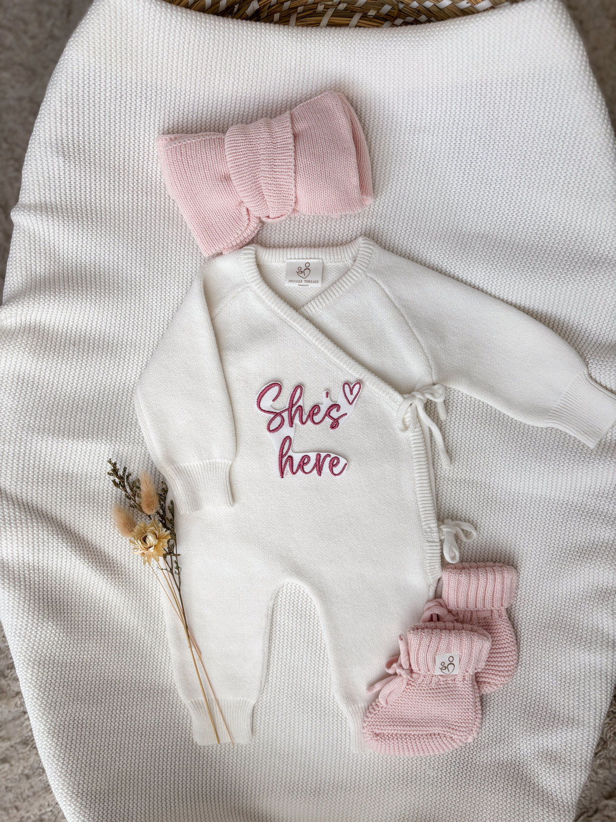 Personalised ivory wrap baby romper with pink embroidery, matching knitted headband and booties