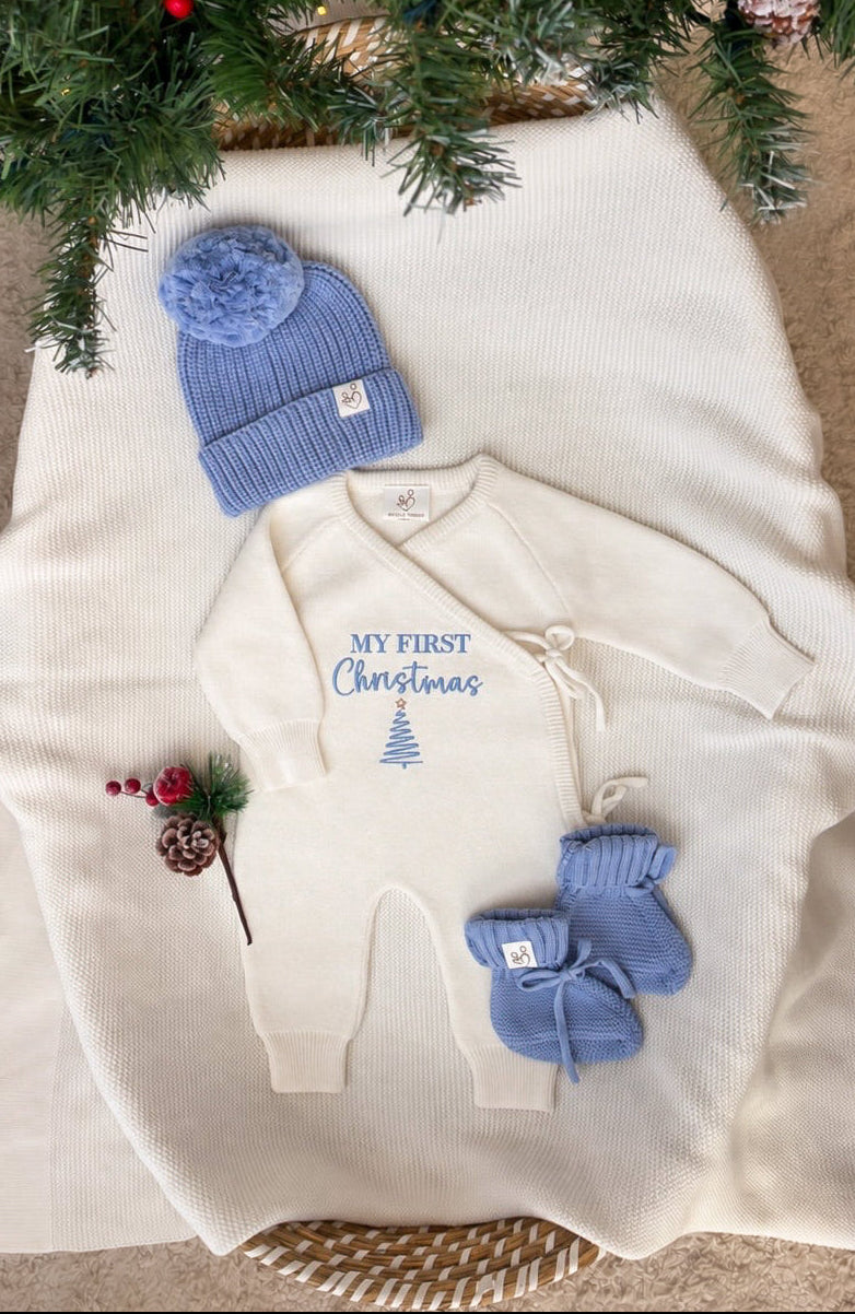 Personalised ivory My First Christmas baby wrap romper with blue Christmas tree embroidery, matching blue knitted hat and booties