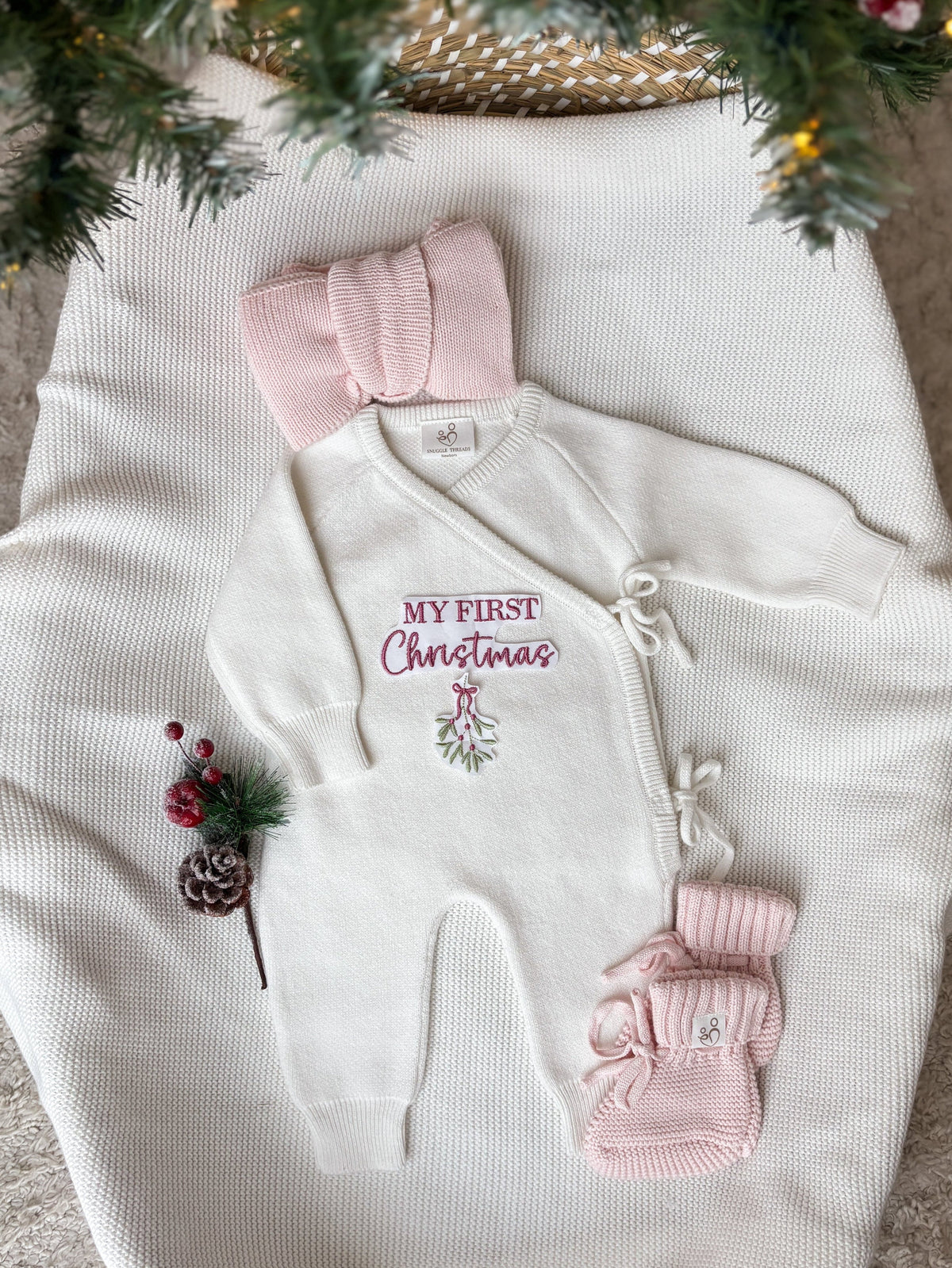 Personalised ivory My First Christmas wrap romper with pink embroidery and mistletoe design