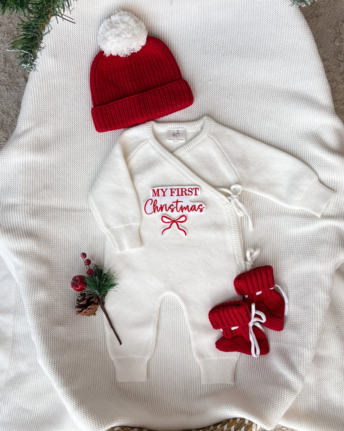 Personalised My First Christmas ivory knit baby wrap romper with red bow embroidery, matching red hat and booties