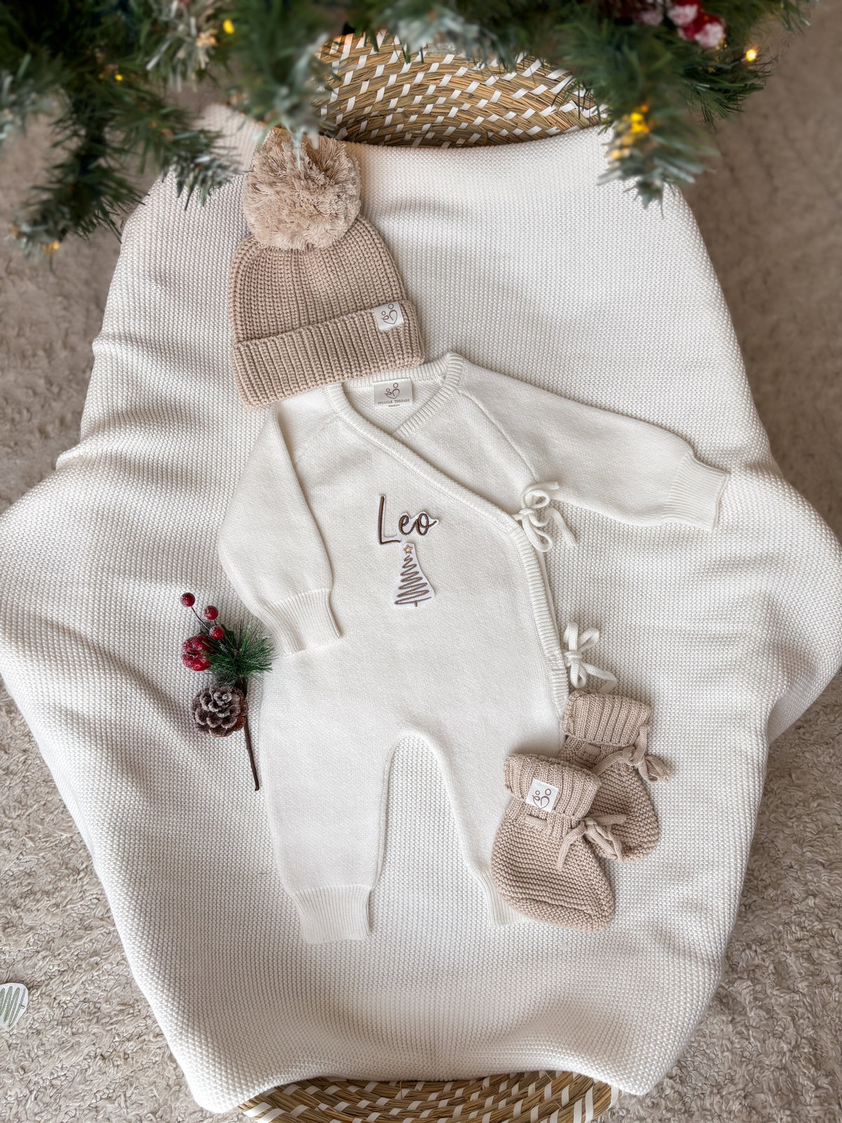 Personalised Christmas wrap romper with name and Christmas tree design, beige knitted hat and baby booties